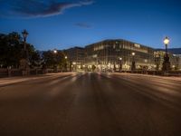 the city skyline is at night from the street level with traffic and pedestrians walking on it