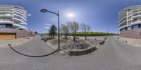 a fisheye picture of a road and a building area in the middle of it