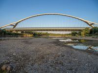 there are two very long bridges that are above the river shore at dusk here, and you can see how close them are