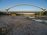 there are two very long bridges that are above the river shore at dusk here, and you can see how close them are