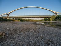 there are two very long bridges that are above the river shore at dusk here, and you can see how close them are