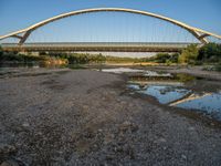 there are two very long bridges that are above the river shore at dusk here, and you can see how close them are