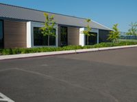 the empty street outside of the building with the parking space at the edge of it