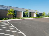 the empty street outside of the building with the parking space at the edge of it