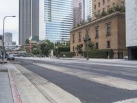 a large city street with lots of tall buildings and trees in the middle of it