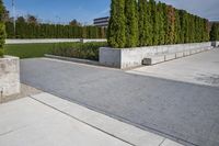 the concrete planters in the foreground is designed to look like they are walking along