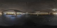 the empty parking garage is empty for this man to use while he rides on his skateboard