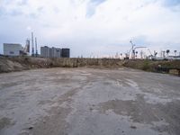 a dirty, empty lot on a construction site in the countryside area of an industrial city