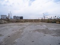 a dirty, empty lot on a construction site in the countryside area of an industrial city