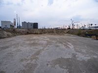 a dirty, empty lot on a construction site in the countryside area of an industrial city