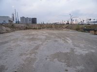 a dirty, empty lot on a construction site in the countryside area of an industrial city