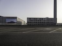 parking spaces with cars and buildings in background at sunset or sunrise or sunrise with the sun rising