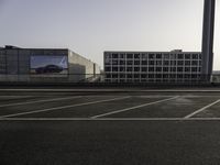 parking spaces with cars and buildings in background at sunset or sunrise or sunrise with the sun rising