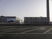 parking spaces with cars and buildings in background at sunset or sunrise or sunrise with the sun rising