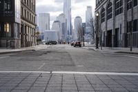 there are cars driving on the road in front of some tall buildings and a few other tall buildings