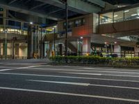 an image of outside of the night time building with the lights turned on and the streets empty