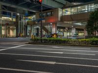 an image of outside of the night time building with the lights turned on and the streets empty