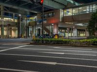 an image of outside of the night time building with the lights turned on and the streets empty