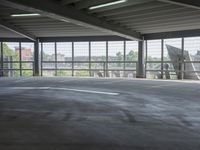 empty large open parking space with an area that looks out onto the countryside and outside