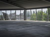 empty large open parking space with an area that looks out onto the countryside and outside