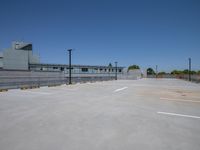 empty parking lot with building in the background and sky in the foreground in the background