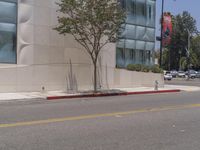 a red fire hydrant sitting on the side of a street next to a building