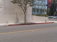 a red fire hydrant sitting on the side of a street next to a building