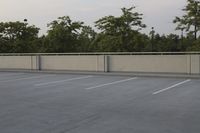 a man on a skateboard doing a trick in the middle of a parking lot