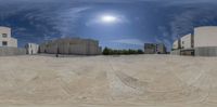 there is a ball being used as a 360 - view camera in this image there are buildings and a skateboard ramp behind them