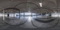 a view of the inside of a large indoor space setting with circular mirrors on the floor