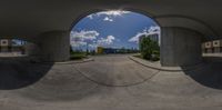 a view of the bottom of the concrete building from inside the cement circular panoramic shot