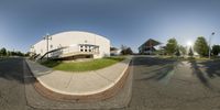 a fish eye view of an intersection in a large white building with a staircase down the side