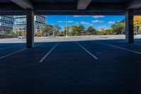 empty parking space under an overpass with a blue sky background, with the sun shining through the clouds