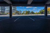 empty parking space under an overpass with a blue sky background, with the sun shining through the clouds