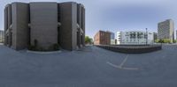 a panoramic view of a skate park with buildings and sky in the background