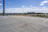 parking lot with parking lot in the background, near highway, traffic, and large building