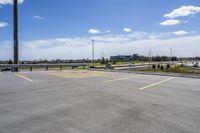 parking lot with parking lot in the background, near highway, traffic, and large building