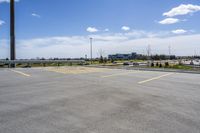 parking lot with parking lot in the background, near highway, traffic, and large building