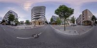 multiple views from a circular angle of a street in urban area near apartment building and bicycle