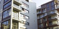 there are several buildings with different balconies on them, as well as a bench