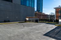 a clock is standing next to a parking garage and a building with windows on it