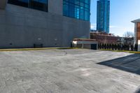 a clock is standing next to a parking garage and a building with windows on it