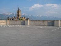 several large empty parking spaces in the city with buildings nearby in front of them -