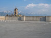 several large empty parking spaces in the city with buildings nearby in front of them -