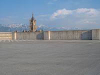 several large empty parking spaces in the city with buildings nearby in front of them -