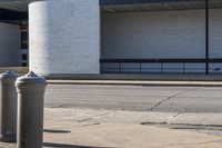 an old fire hydrant sitting next to a building on the side of the road