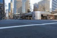 the crosswalk near a stoplight at a street intersection with skyscrapers in the background