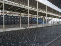 a boat is docked on the side of a road in front of a building that has two levels and a ramp