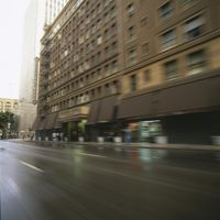 blurred photo of an empty city street in downtown los, with buildings and vehicles on the side