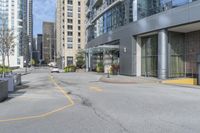 an empty parking lot between high - rise buildings and apartments with parking meters down